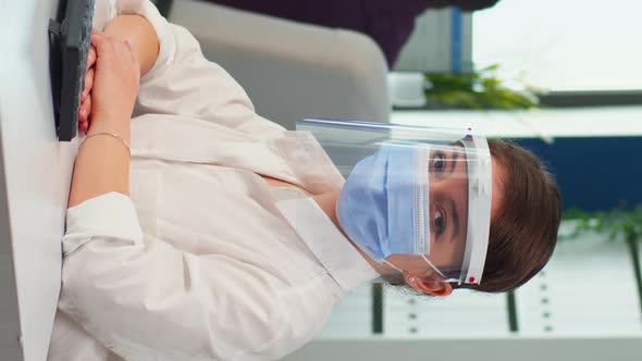 Vertical Video Manager Woman with Visor and Protection Mask Looking at Camera