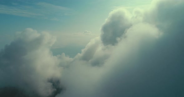 Aerial Fly Above Clouds with Blue Sky in Backgroubnd on Beautiful Sunny Day