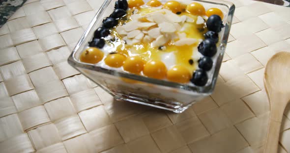 Yogurt with blueberries and golden berries in bowl 4k