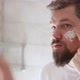 Portrait of Man in White Tshirt Applying Cream on His Face at Bathroom - VideoHive Item for Sale