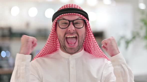 Excited Young Arab Businessman Celebrating Success