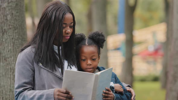 Closeup Young Mom Cute Daughter Sitting in City Park Mother Hugging Little Girl Kid African American