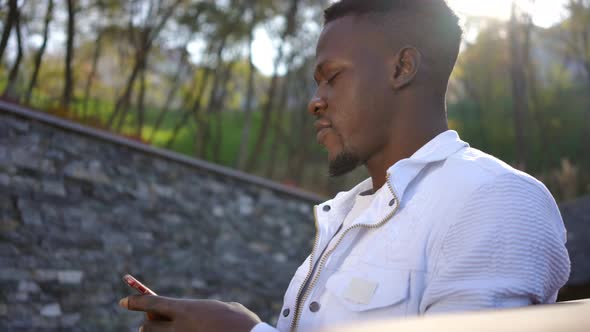 Side View Happy Man Admiring Beauty of Autumn Nature Messaging Online on Smartphone in Slow Motion