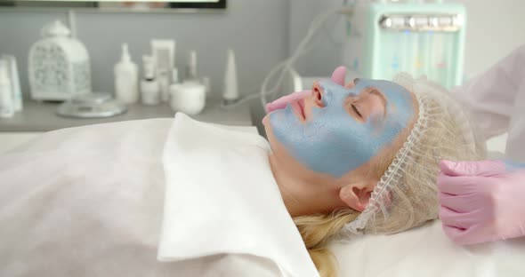 Applying A Cosmetic Mask On The Face In A Beauty Salon