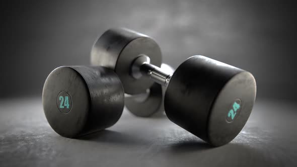 Pair of dumbells isolated on a grey concrete floor. Strenght, fit concept.