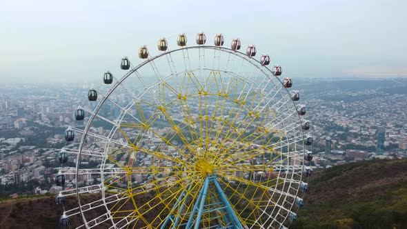 Ferris Wheel Against The Backdrop Of The City