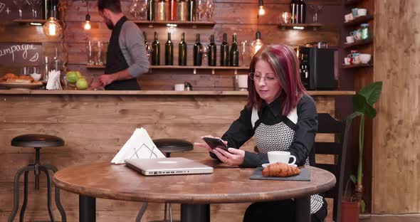 Enjoying a Cup of Fresh Coffee and Texting on Smartphone