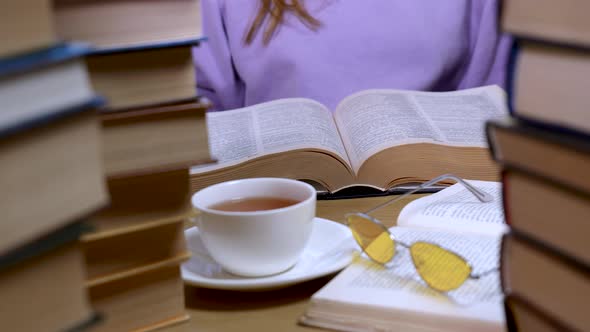 Female Hand Flipping Through the Pages of a Book Closeup