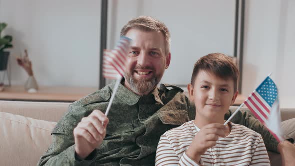 Army Officer and his Son Waving American Flags