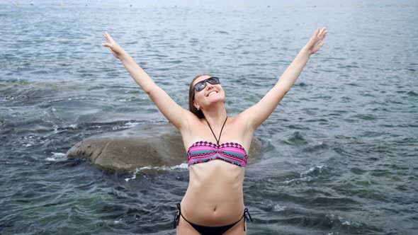 Woman Poses Holding Arms Up Sharing Positive Emotions