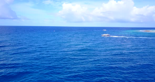 Luxury drone travel shot of a sandy white paradise beach and blue sea background in 4K