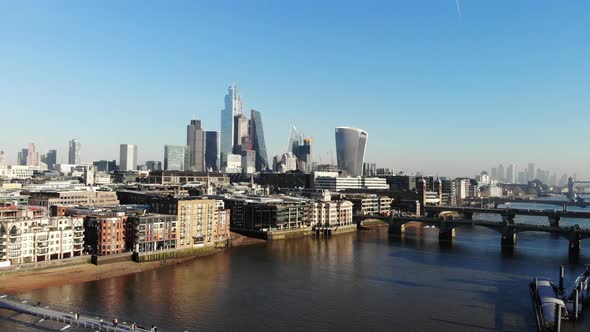 Flying over the Millennium Bridge towards the London's Financial District on a hazy sunny day