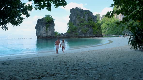 Couple Men and Woman on the Beach of Koh Hong Island Krabi Thailand Asian Woman and European Men on