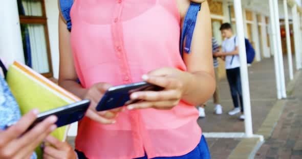 Schoolgirls using mobile phone