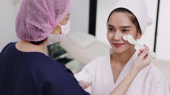 Beauty clinic concept. Young woman getting professional facial procedure.