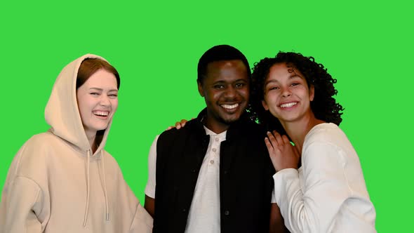 Two African American Teens Having Fun with Their Caucasian Friend on a Green Screen Chroma Key