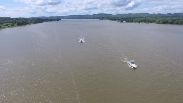 aerial pontoon boat passes under drone 4k