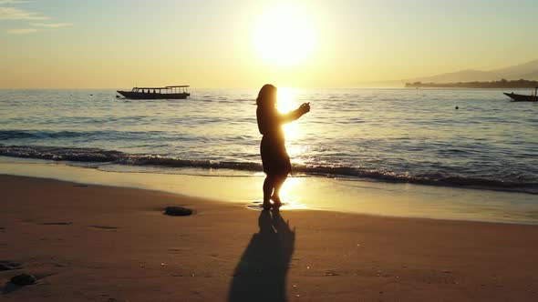 Female model happy and smiling on marine coastline beach wildlife by turquoise ocean with white sand