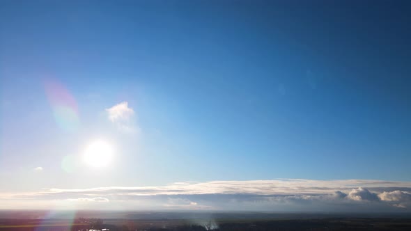 Bright sun light, sunbeams, flares shining through sunrise clouds, cloudscape