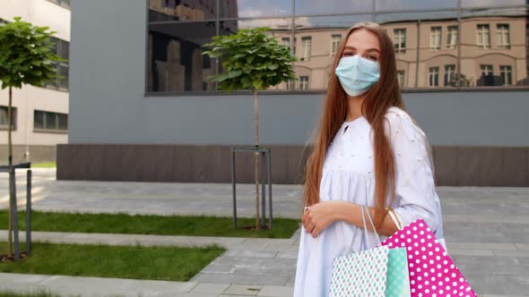 Teenager Girl with Multicolor Shopping Bags Wearing Protect Mask. Black Friday During Coronavirus