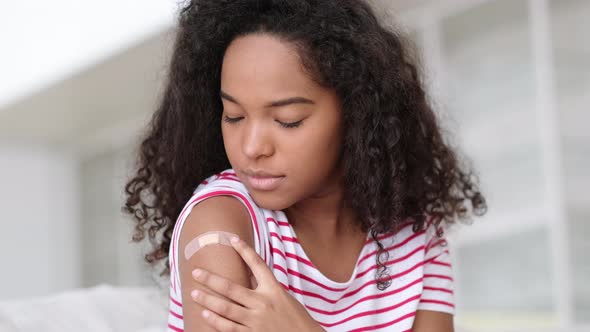 Vaccinated African American Woman Showing Arm with Medical Plaster Patch Plaster On Shoulder Black