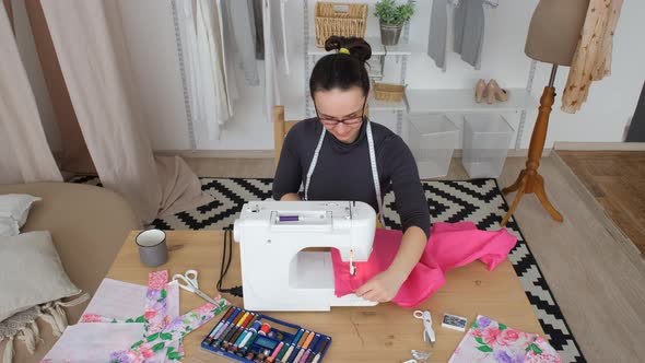 Woman Stitching Fabric Using a Sewing Machine