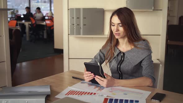 Woman Talking By the Tablet Decides Business Affairs