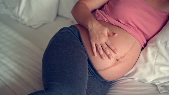 Happy Pregnant Woman and Expecting Baby at Home