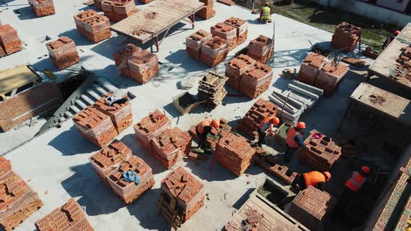 Aerial View Builders Working on Construction and Laying Bricks
