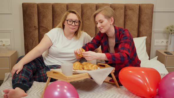 Lgbt Couple in Bed Having Breakfast on the Bedside Table
