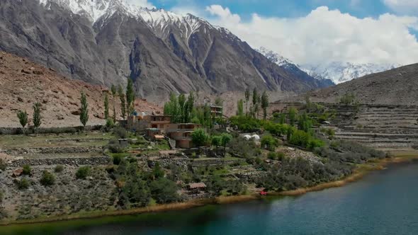 Aerial View Of Village By Lake Borith In Gojal At Hunza Valley. Dolly Back