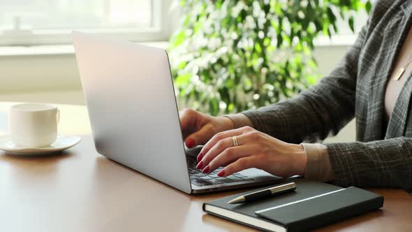 Focused business woman hands entrepreneur typing fast on laptop doing research.