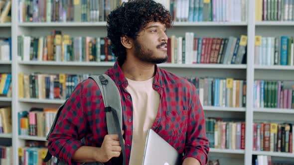 Happy Confident Indian or Arabian Male Student of University in Stylish Wear with Backpack and