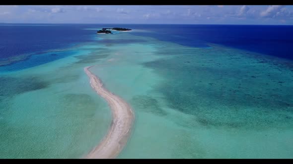 Aerial flying over sky of paradise tourist beach adventure by turquoise sea with white sand backgrou