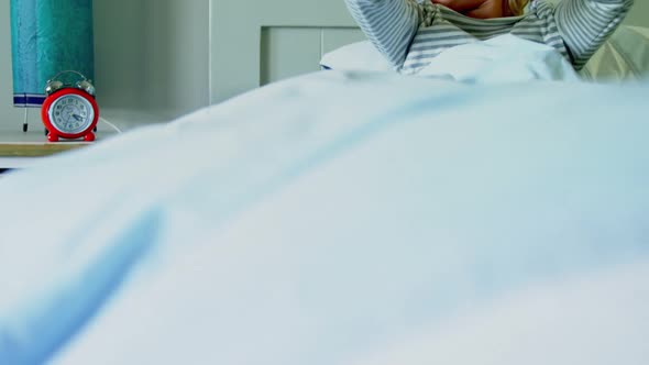 Boy yawning on bed in the bedroom at home