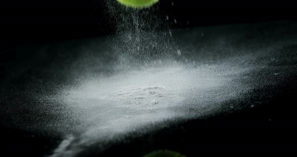 Bouncing ball with powder on black background