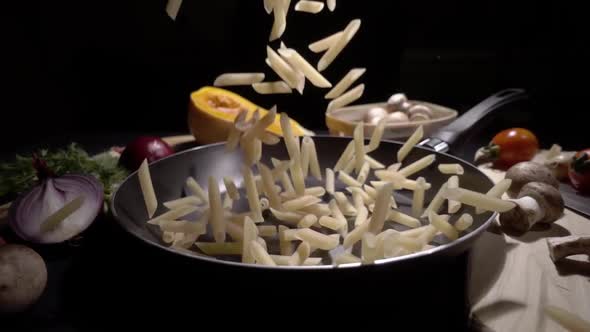 Pasta Flying in the Air on a Black Background in Slow Motion