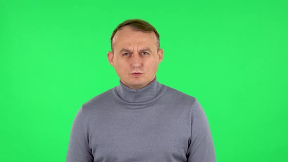 Portrait of Male Looking at Camera with Anticipation, Then Very Upset. Green Screen