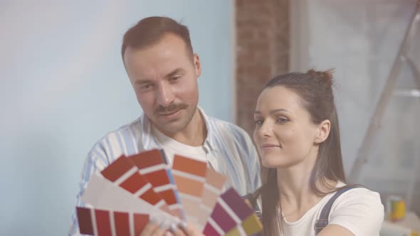 Happy Couple Looking at Color Samples Doing House Renovation