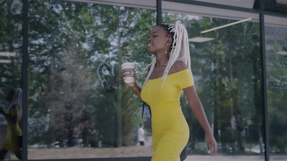 Young African Woman With A Coffee On-The-Go Cup