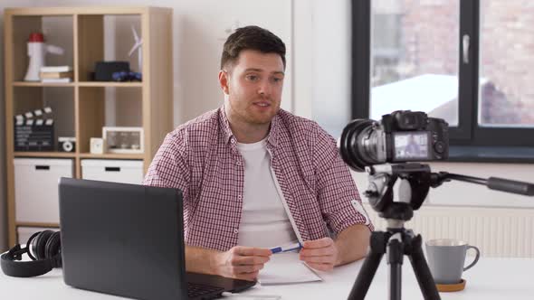 Male Blogger with Camera Videoblogging at Home