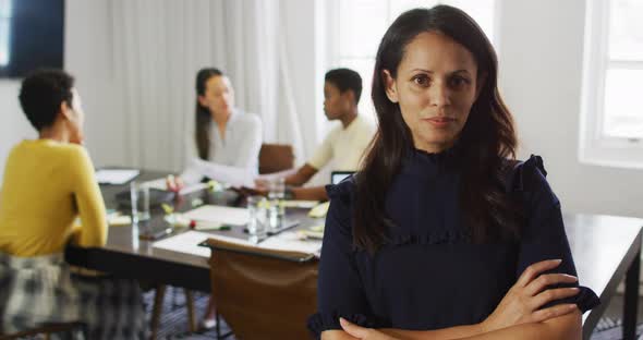 Happy caucasian businesswoman standing in office and looking at camera