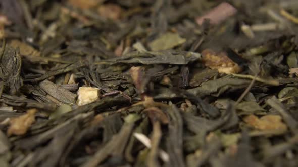 Green tea with hemp and rose bush close-up. Falling in slow motion