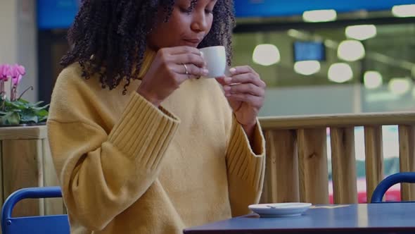 Brazilian Woman Having a Coffee on a Terrace