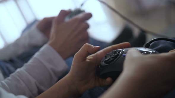 Closeup Hands Pressing Control Buttons of Joystick