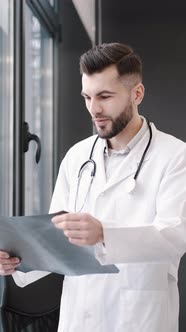 Medical Worker Looking at Xray at His Office