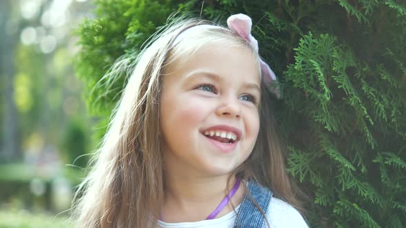 Portrait of Pretty Child Girl Standing Outdoors in Summer Park Smiling Happily