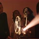 Young group of friends turning on vintage projector for movie screening - VideoHive Item for Sale