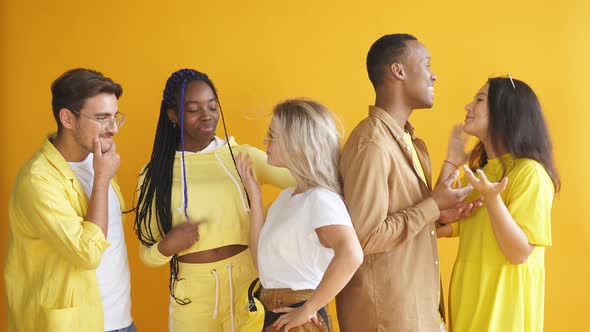 Portrait of Diverse Seriously Looking Students Isolated on Yellow Background.