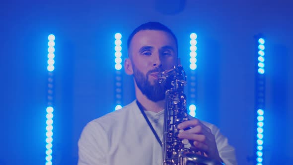 Live Performance of Saxophonist Man with Saxophone Dancing on Concert Musician Stage with Lights